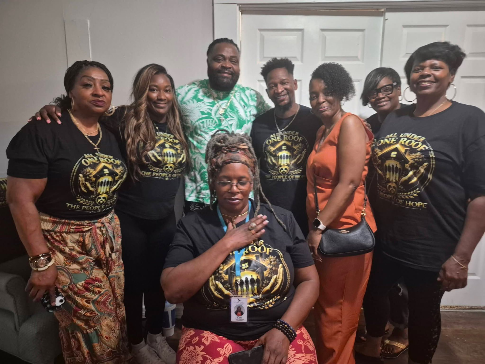 The People of Hope team in All Under One Roof shirts at the brick dedication ceremony